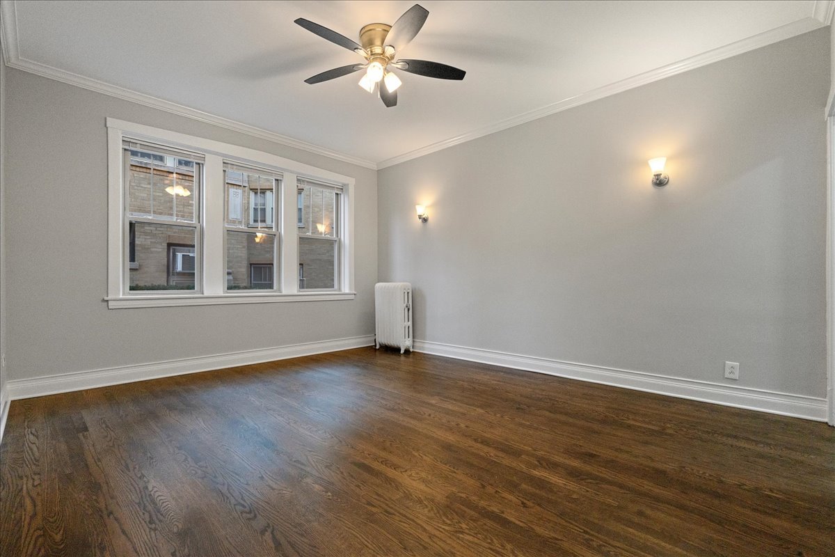 905 West Altgeld Street, Unit 1B Chicago, IL 60614 - Photo 5 of 11 a view of empty room with wooden floor and fan