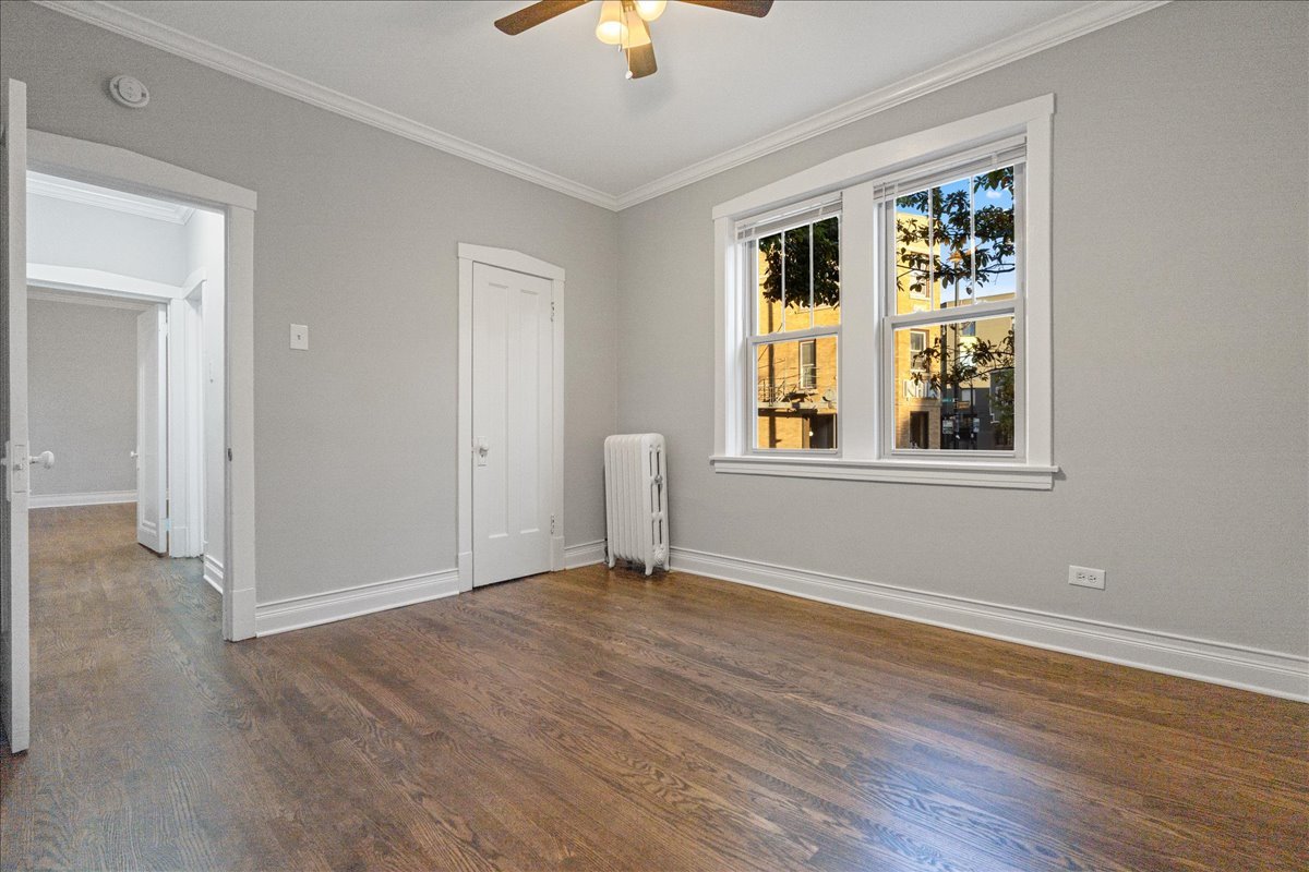 905 West Altgeld Street, Unit 1B Chicago, IL 60614 - Photo 6 of 11 a view of an empty room with wooden floor and a window