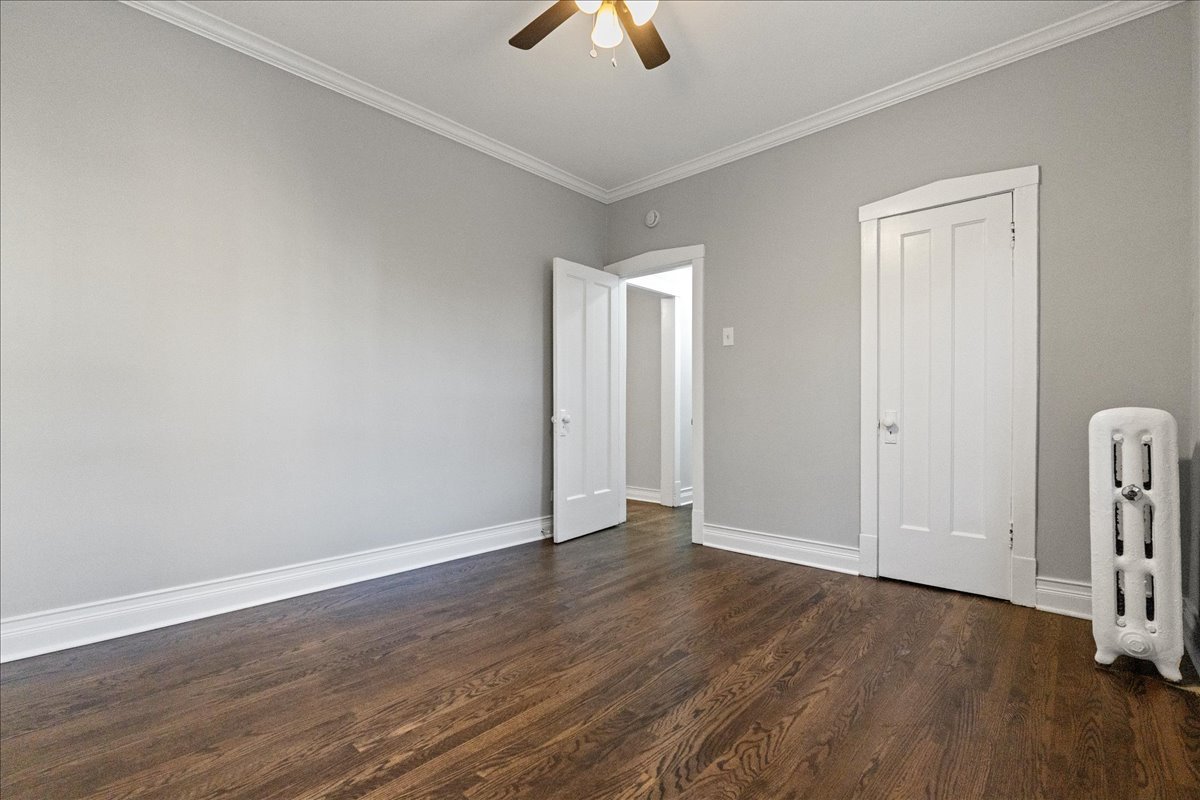 905 West Altgeld Street, Unit 1B Chicago, IL 60614 - Photo 7 of 11 an empty room with wooden floor chandelier fan and windows