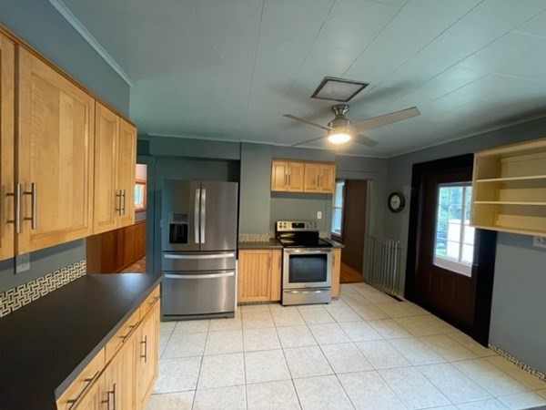 124 Wells Street Greenfield, MA 01301 - Photo 4 of 19 a kitchen with granite countertop a refrigerator and a stove top oven