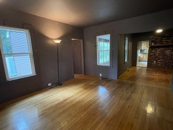 124 Wells Street Greenfield, MA 01301 - Photo 5 of 19 a view of an empty room with wooden floor and a window