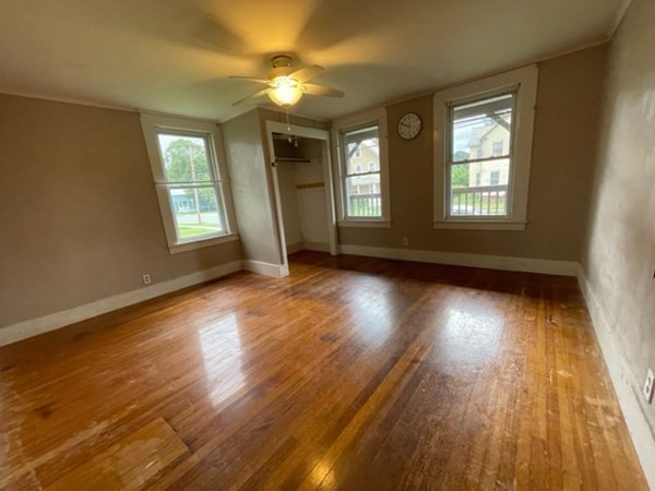 124 Wells Street Greenfield, MA 01301 - Photo 6 of 19 a view of an empty room with wooden floor and a window