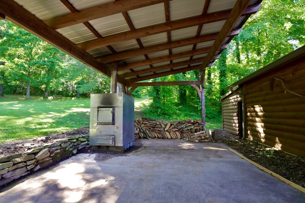 386 County Road 181 Decatur, TN 37322 - Photo 32 of 70 a backyard of a house with a garden and outdoor seating