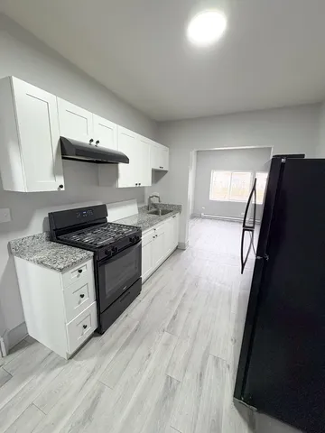a kitchen with stainless steel appliances granite countertop a stove and a refrigerator