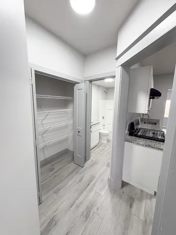 a room with a wooden floor and a sink