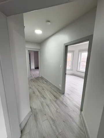 a view of hallway with wooden floor