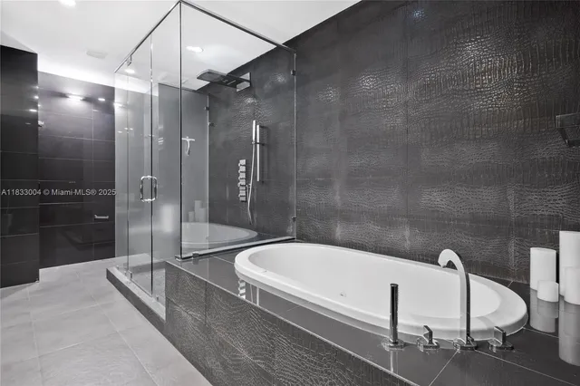 a bathroom with a bathtub and a shower