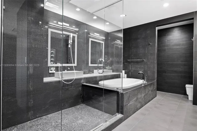 a bathroom with a double vanity sink a large mirror and a shower