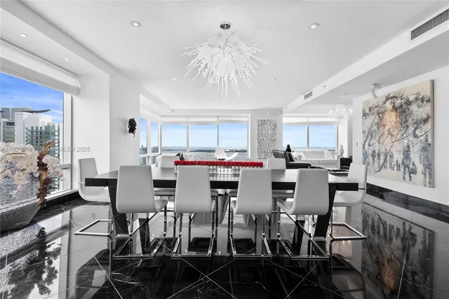 a view of a dining room with furniture and chandelier