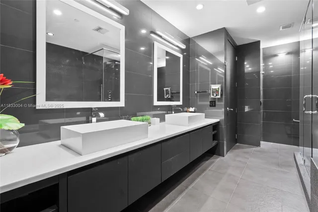 a bathroom with double vanity sinks double vanity and a shower