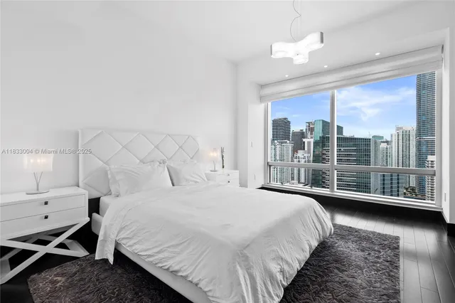 a bedroom with a bed and a large window