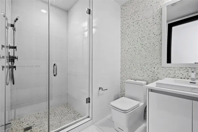 a bathroom with a toilet sink and shower