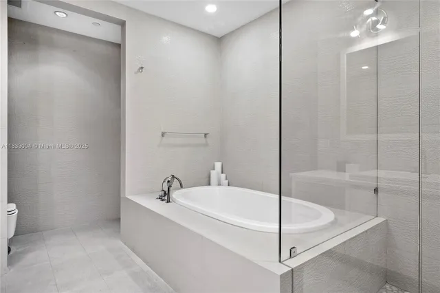 a bathroom with a bathtub and shower