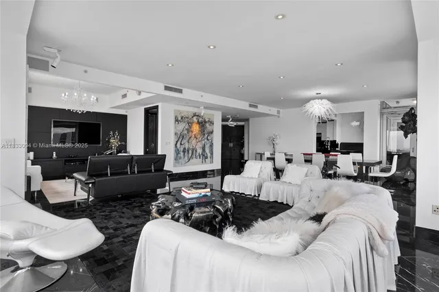 a large bedroom with furniture and a flat screen tv