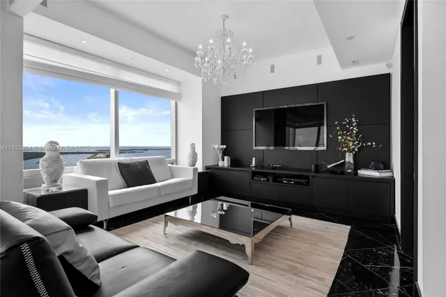 a living room with furniture and a chandelier