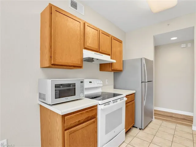 a kitchen with stainless steel appliances a stove a microwave and a refrigerator