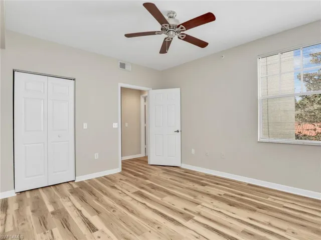 a view of a livingroom with a ceiling fan and wooden floor