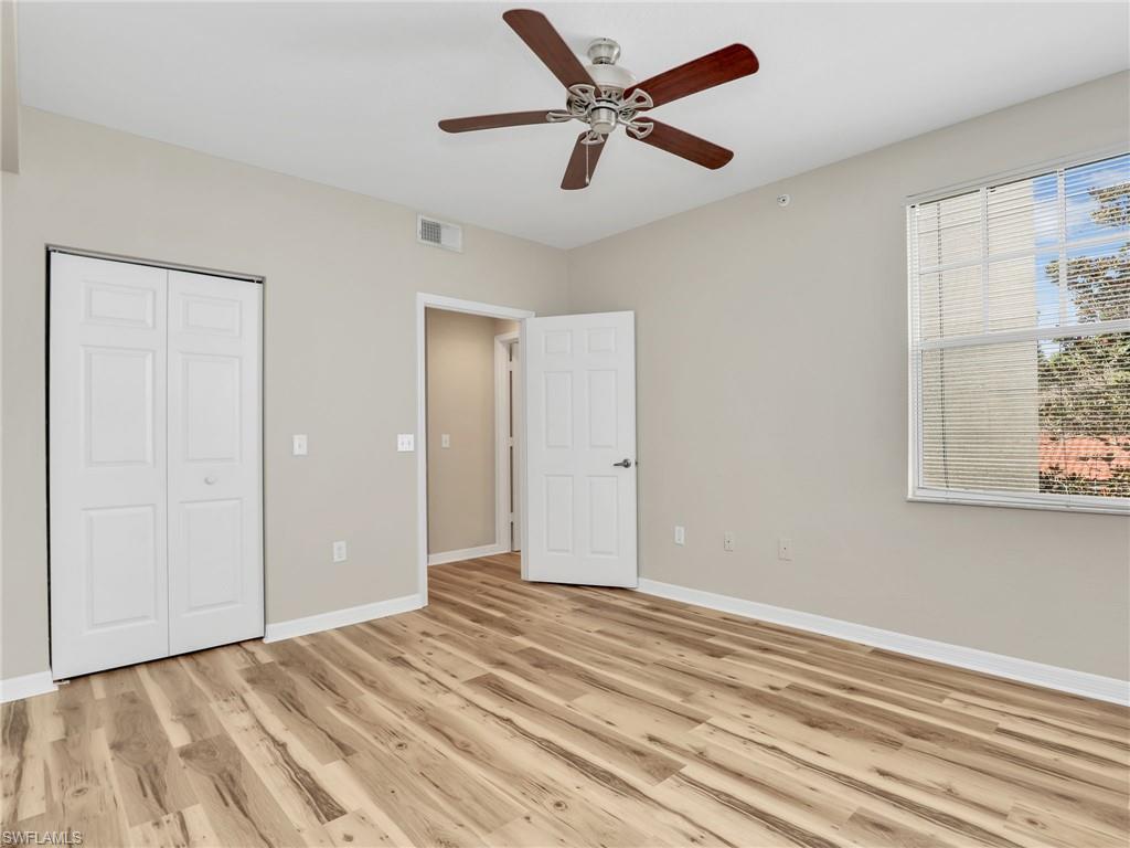 7935 Preserve Circle, Unit 423 Naples, FL 34119 - Photo 16 of 30 a view of a livingroom with a ceiling fan and wooden floor