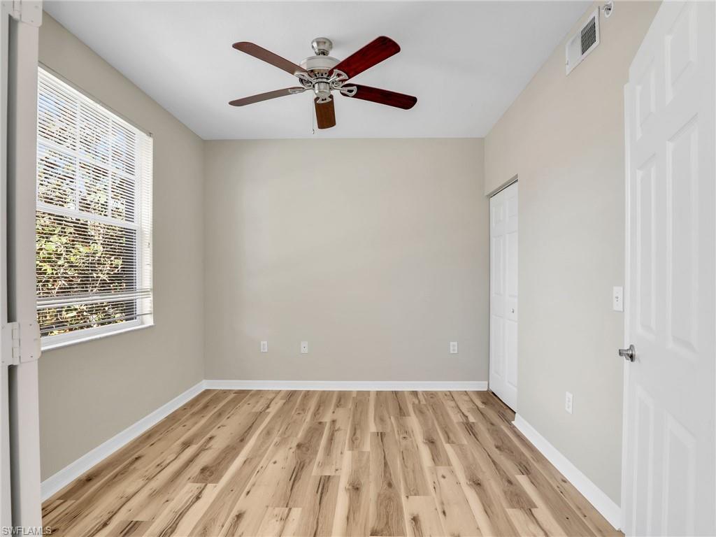7935 Preserve Circle, Unit 423 Naples, FL 34119 - Photo 18 of 30 wooden floor in an empty room with a window