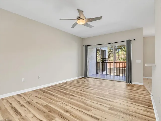 a view of a livingroom with wooden floor and a ceiling fan