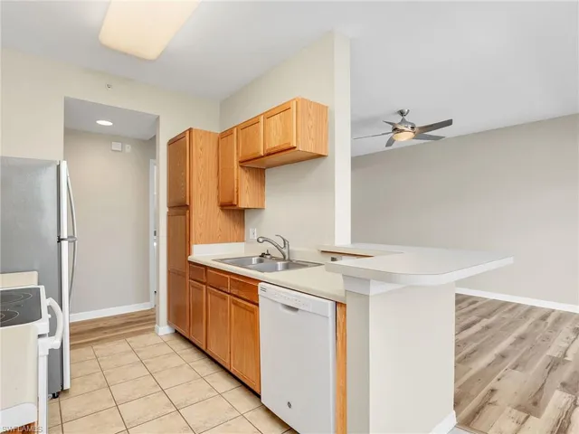 a kitchen with stainless steel appliances granite countertop a sink and a stove
