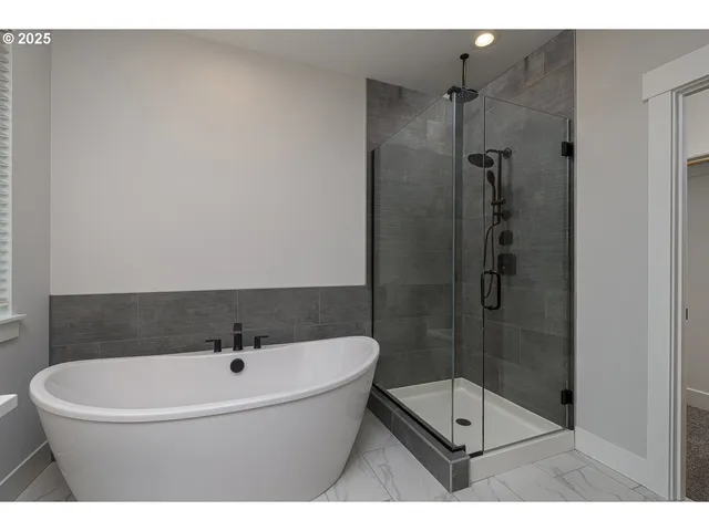 a bathroom with a bathtub and shower