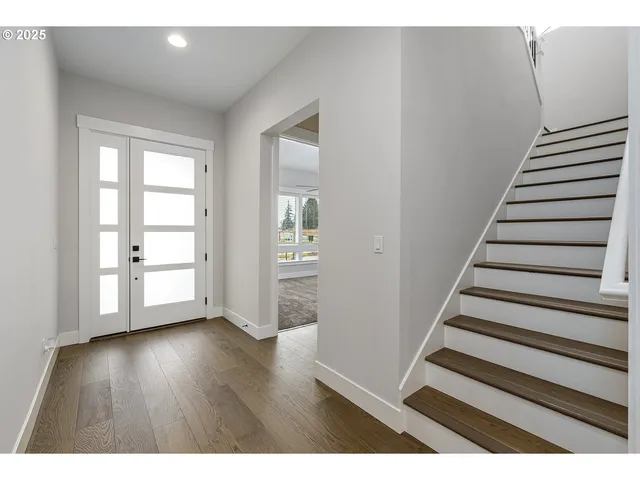 a view of an entryway with wooden floor