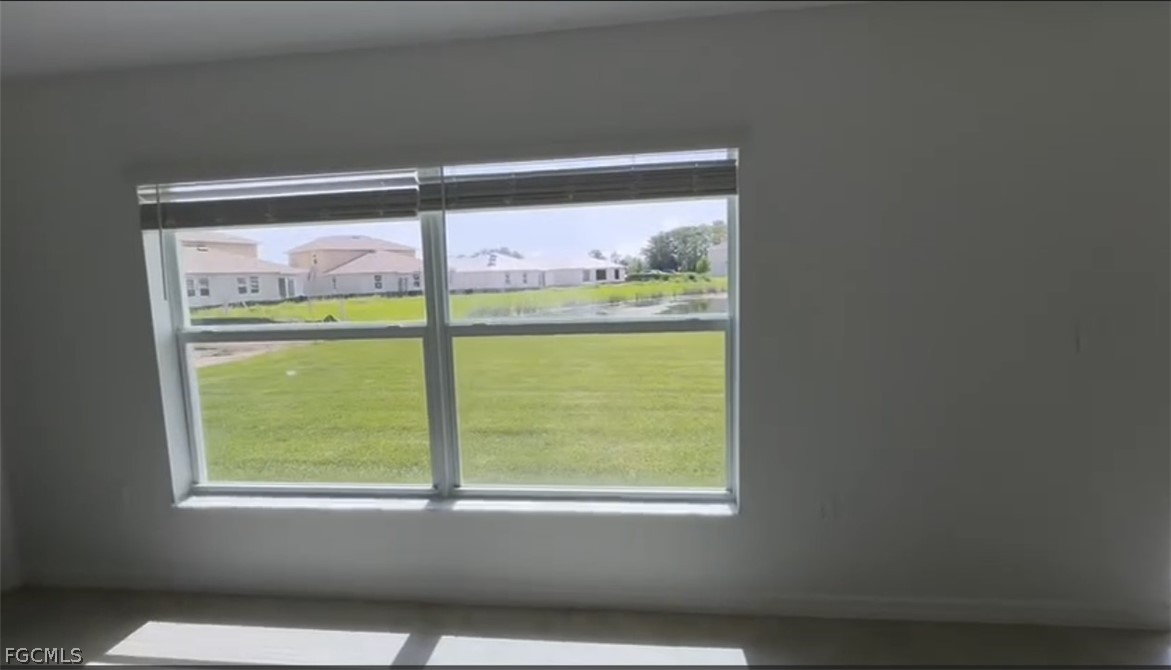 12312 Amber Waves Road Lehigh Acres, FL 33974 - Photo 17 of 33 a view of a small space with wooden floor and a window
