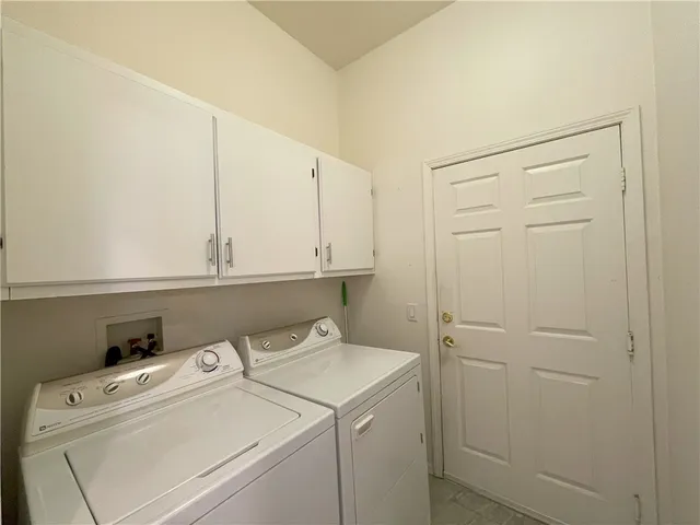 a view of storage and utility room with washer and dryer