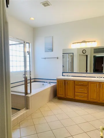 a spacious bathroom with a granite countertop sink and mirror