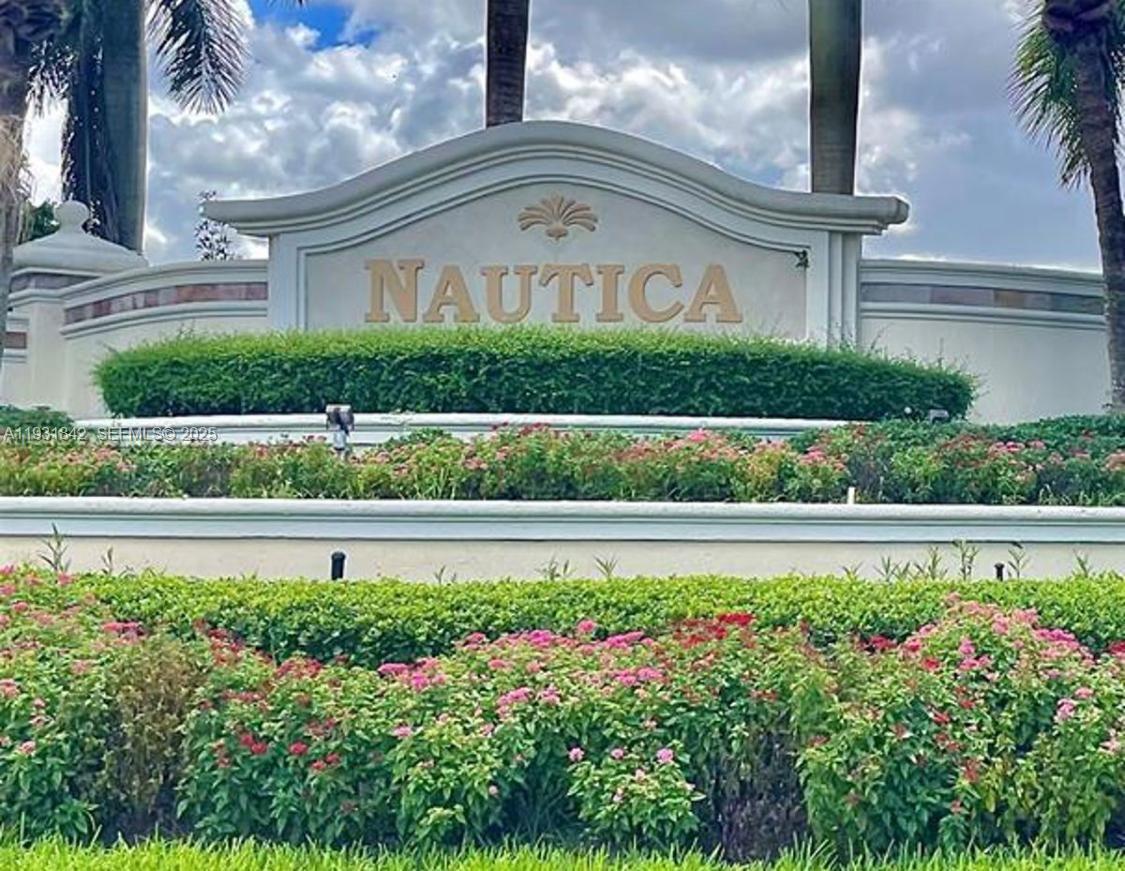 a view of a garden with a fountain in the background
