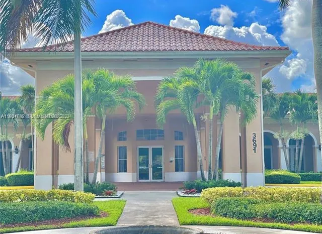 a bathroom with a granite countertop toilet sink and mirror