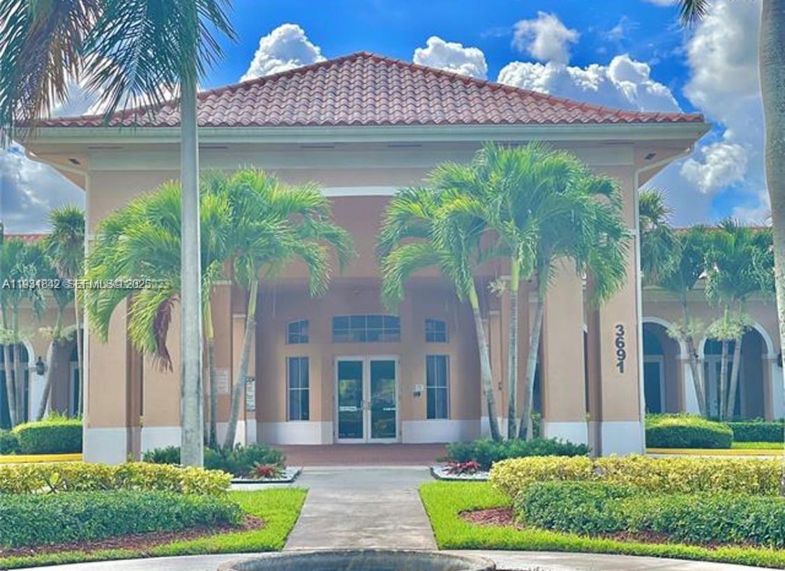 16972 Southwest 33rd Court, Unit 16972 Miramar, FL 33027 - Photo 13 of 15 a front view of a house with garden