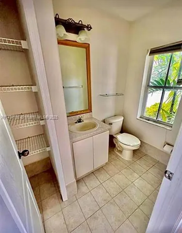 a view of a multi story residential apartment building with a yard