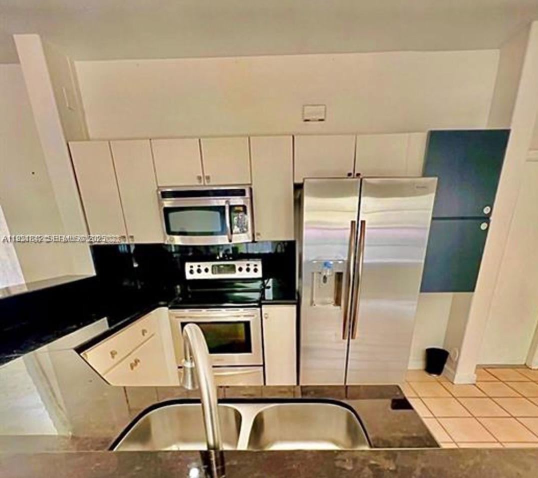 16972 Southwest 33rd Court, Unit 16972 Miramar, FL 33027 - Photo 3 of 15 a kitchen with stainless steel appliances a refrigerator and a stove