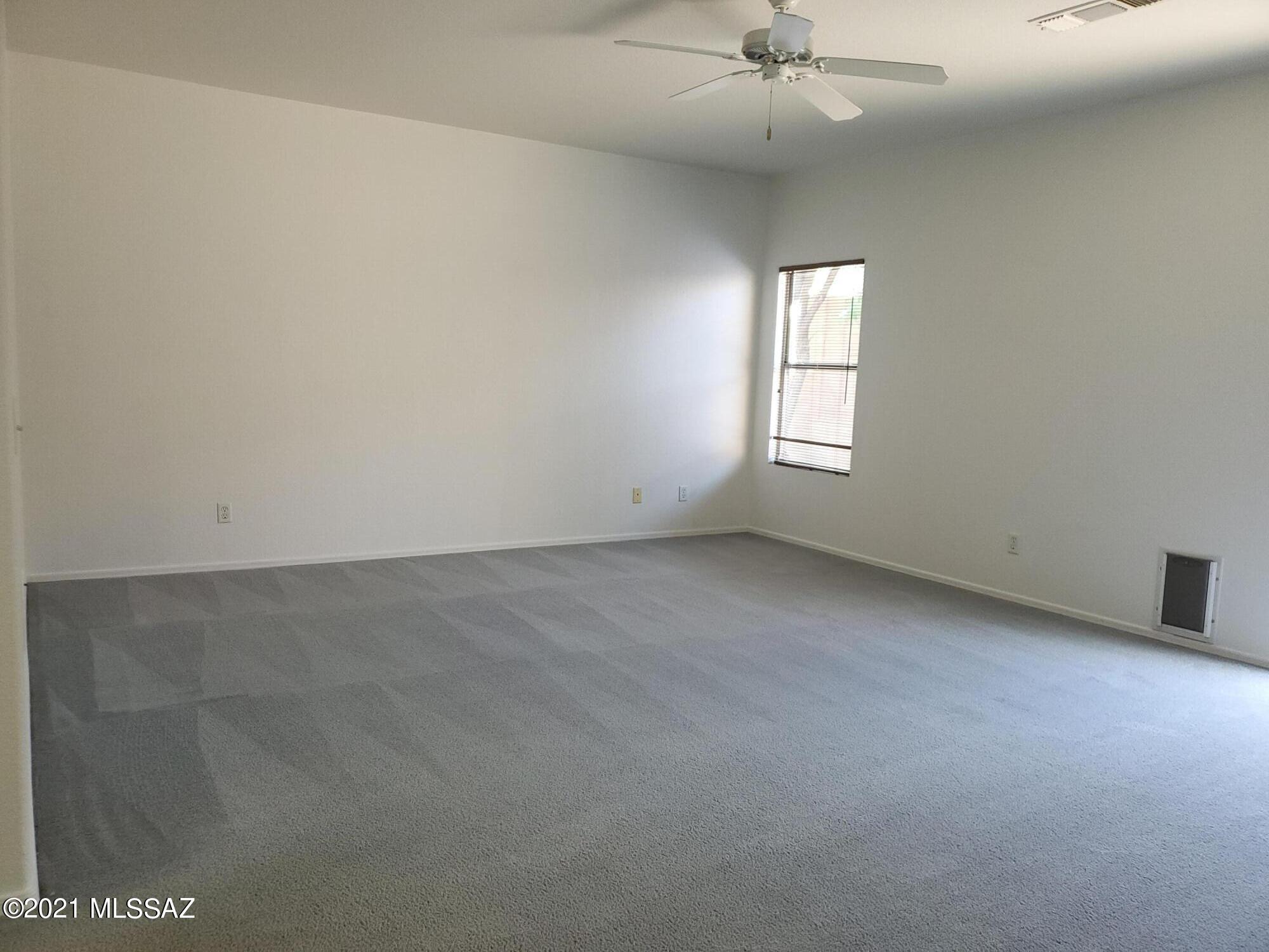 3455 North Boyce Spring Lane Tucson, AZ 85745 - Photo 14 of 21 an empty room with a ceiling fan and window