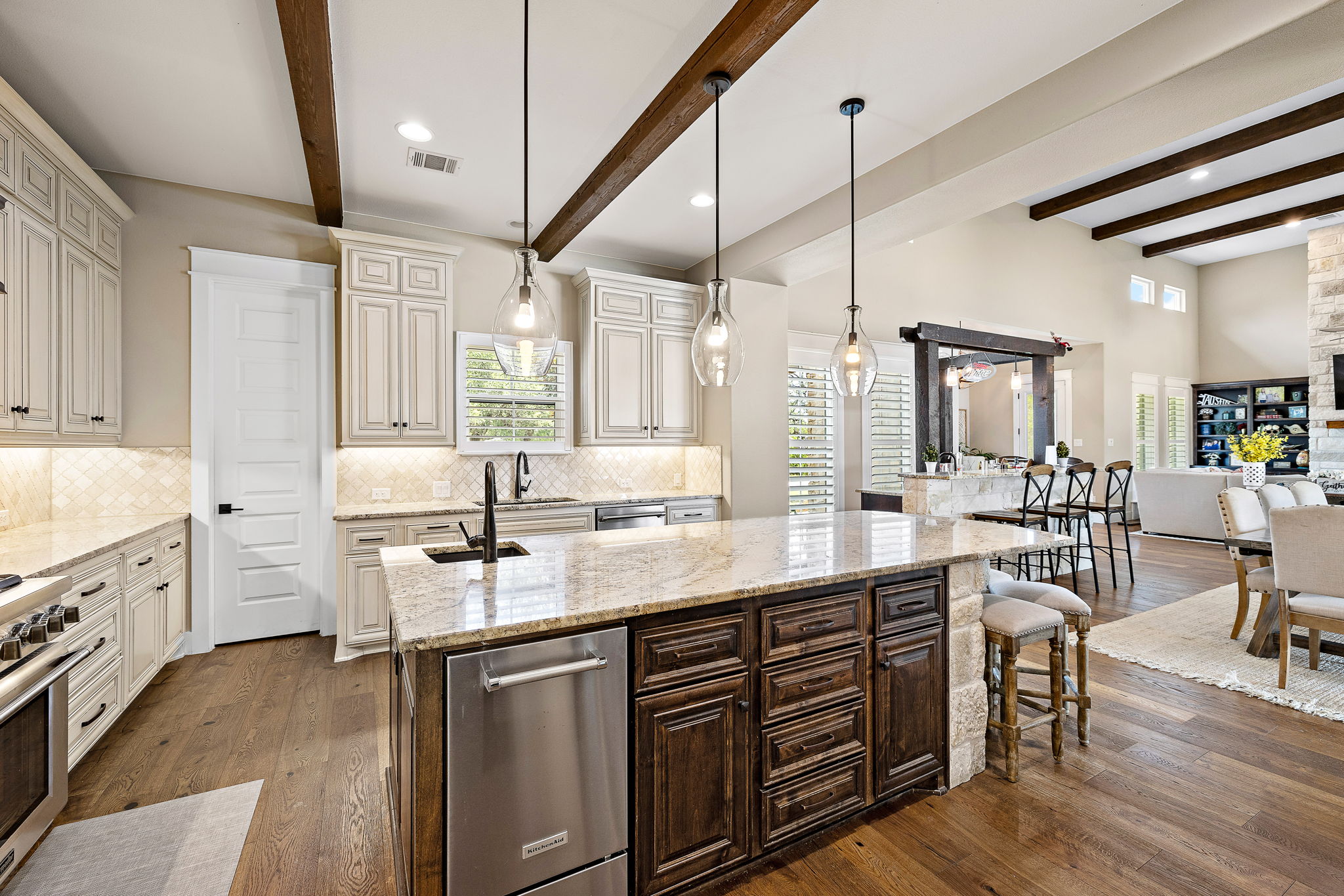 117 Covington Cove Georgetown, TX 78628 - Photo 40 of 40 Kitchen featuring dark wood finished floors, an island with sink, dark brown cabinetry, open floor plan, and light stone countertops