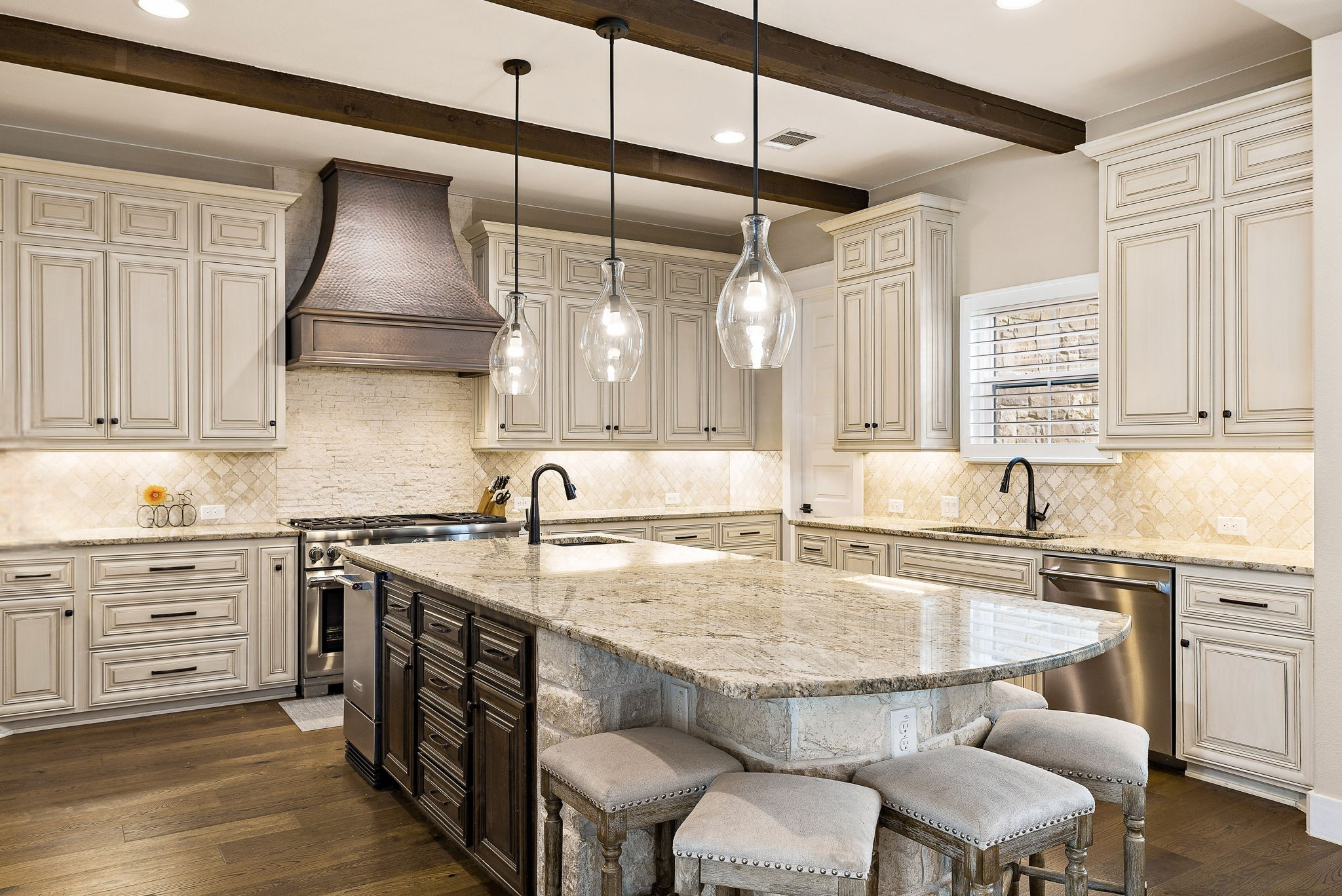 117 Covington Cove Georgetown, TX 78628 - Photo 12 of 40 Kitchen with a kitchen breakfast bar, tasteful backsplash, beamed ceiling, dark wood-style flooring, and light stone countertops