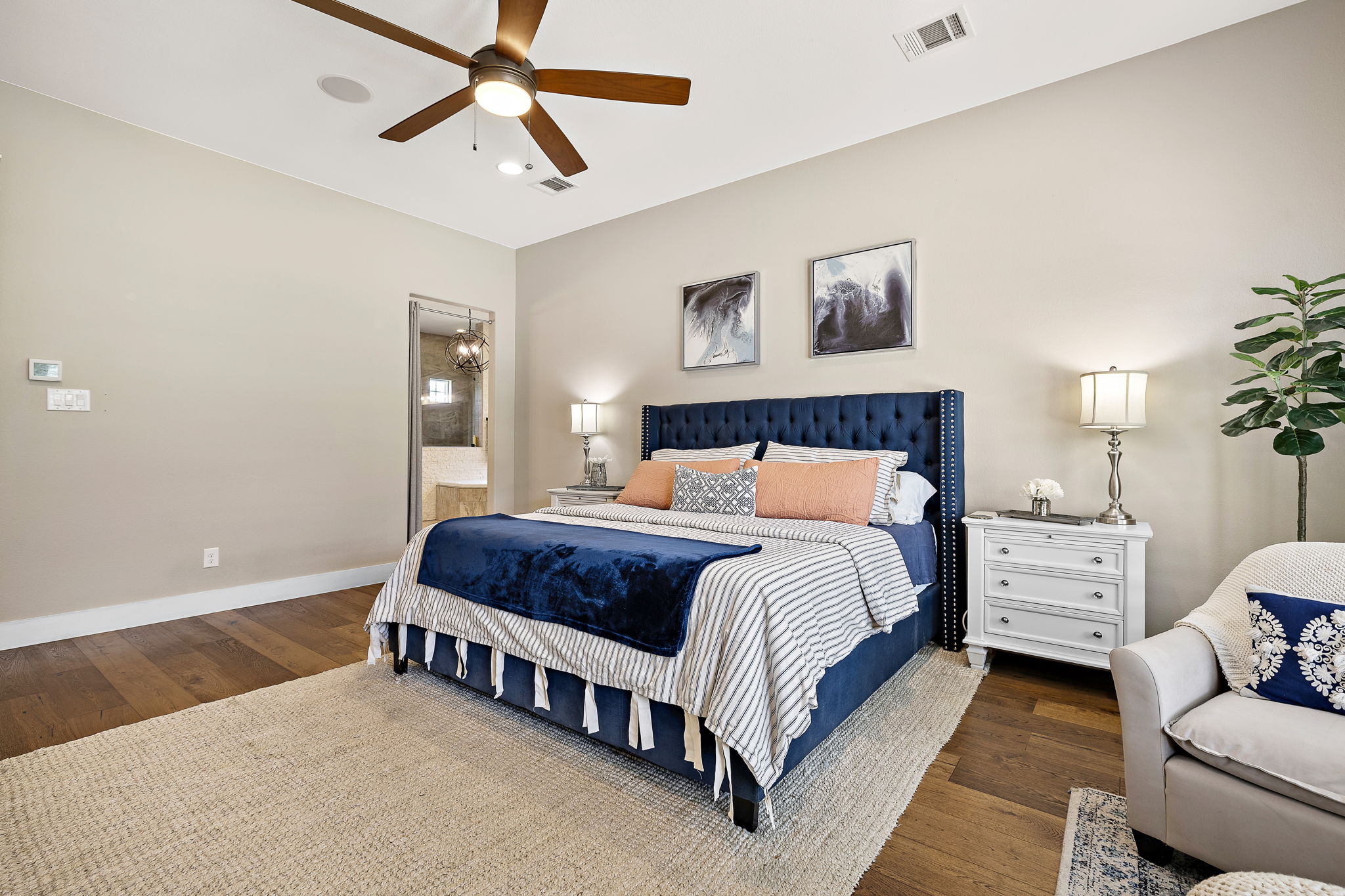 117 Covington Cove Georgetown, TX 78628 - Photo 15 of 40 Bedroom featuring wood finished floors, connected bathroom, and a ceiling fan