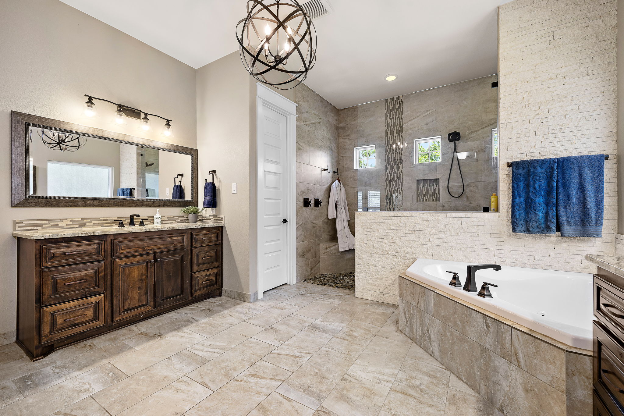 117 Covington Cove Georgetown, TX 78628 - Photo 17 of 40 Bathroom featuring vanity, a bath, walk in shower, recessed lighting, and a chandelier