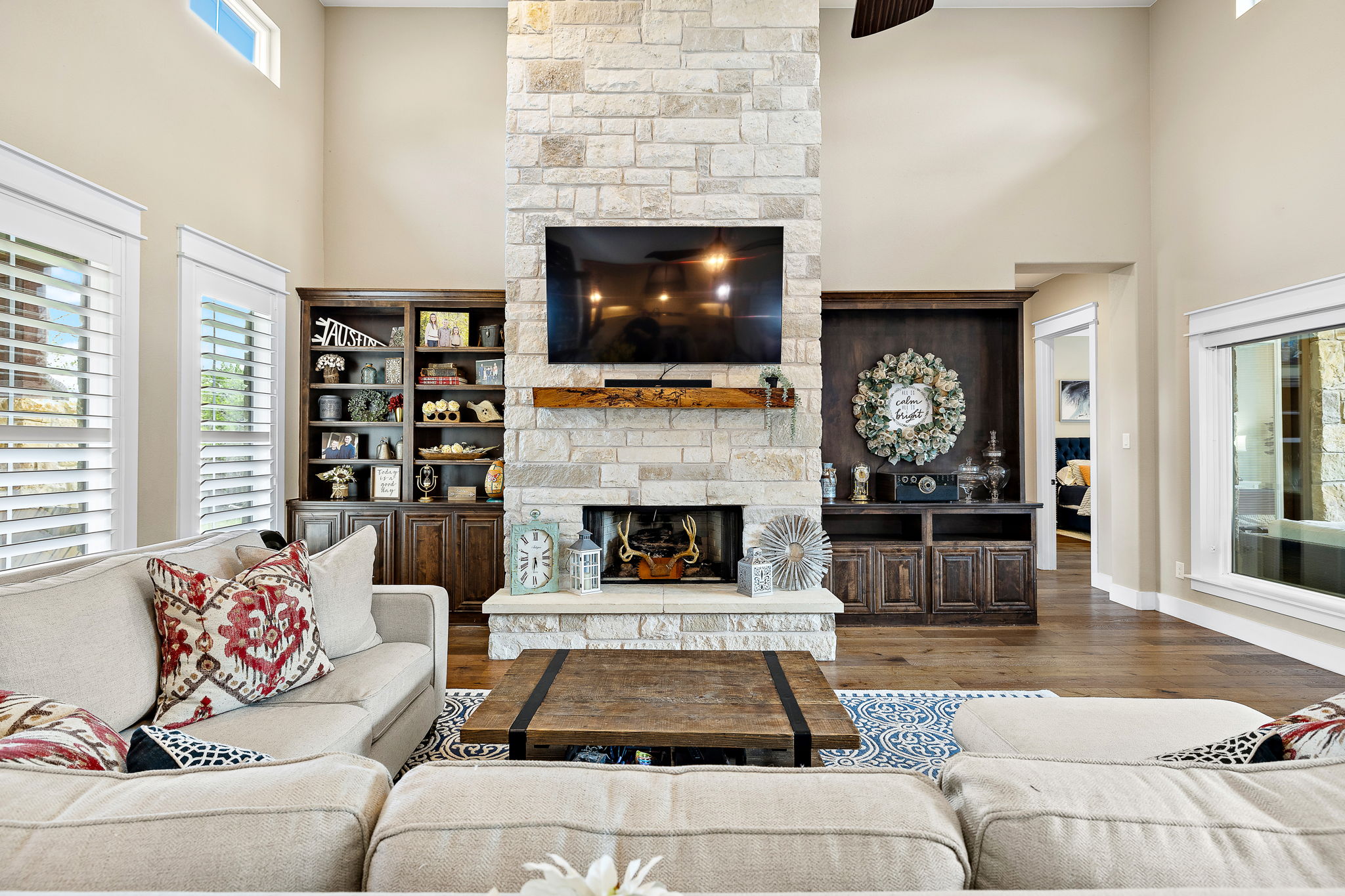 117 Covington Cove Georgetown, TX 78628 - Photo 35 of 40 Living area featuring a fireplace, a towering ceiling, and wood finished floors