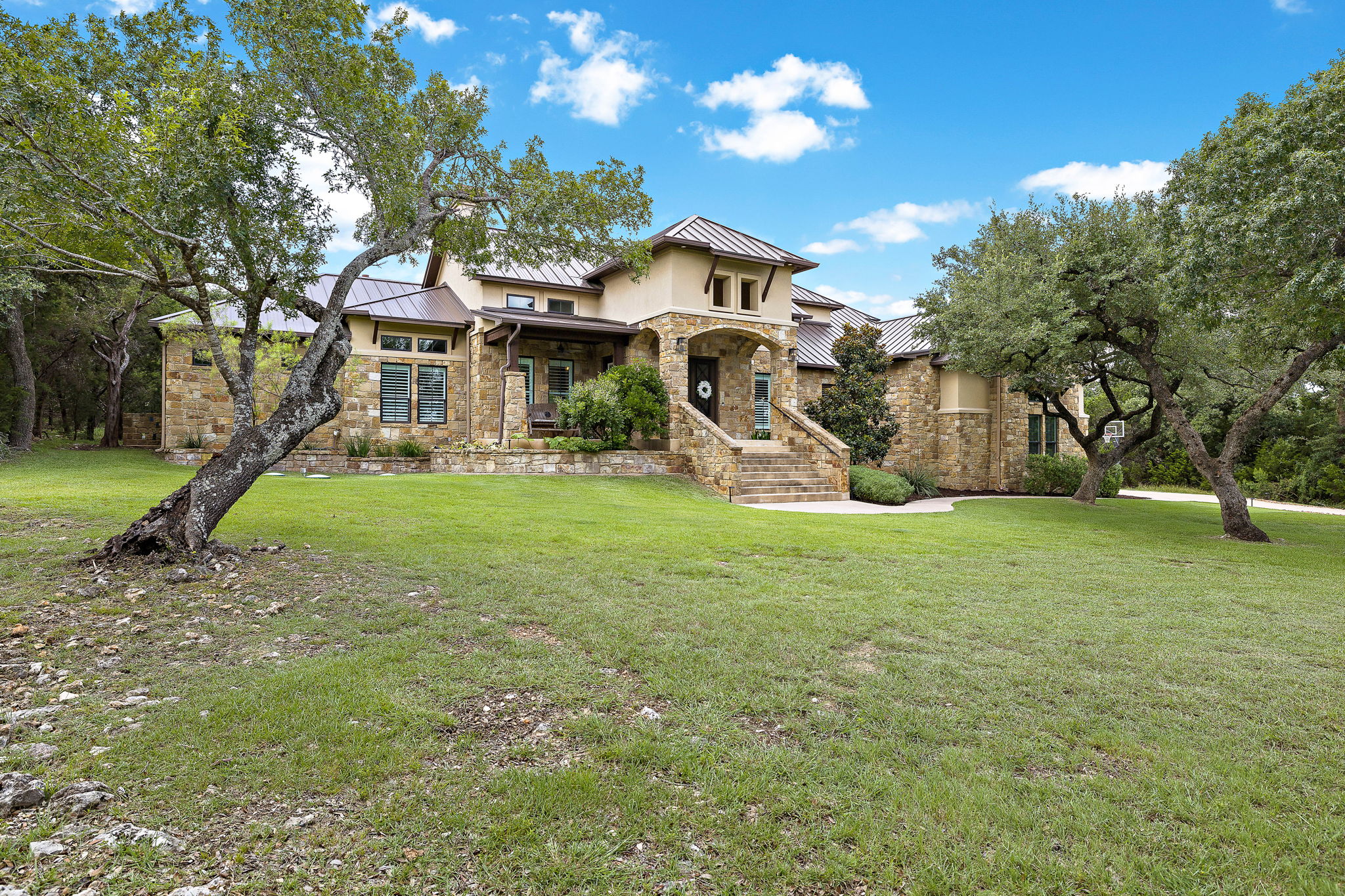 117 Covington Cove Georgetown, TX 78628 - Photo 38 of 40 Prairie-style home with a standing seam roof, stone siding, a metal roof, and a front yard