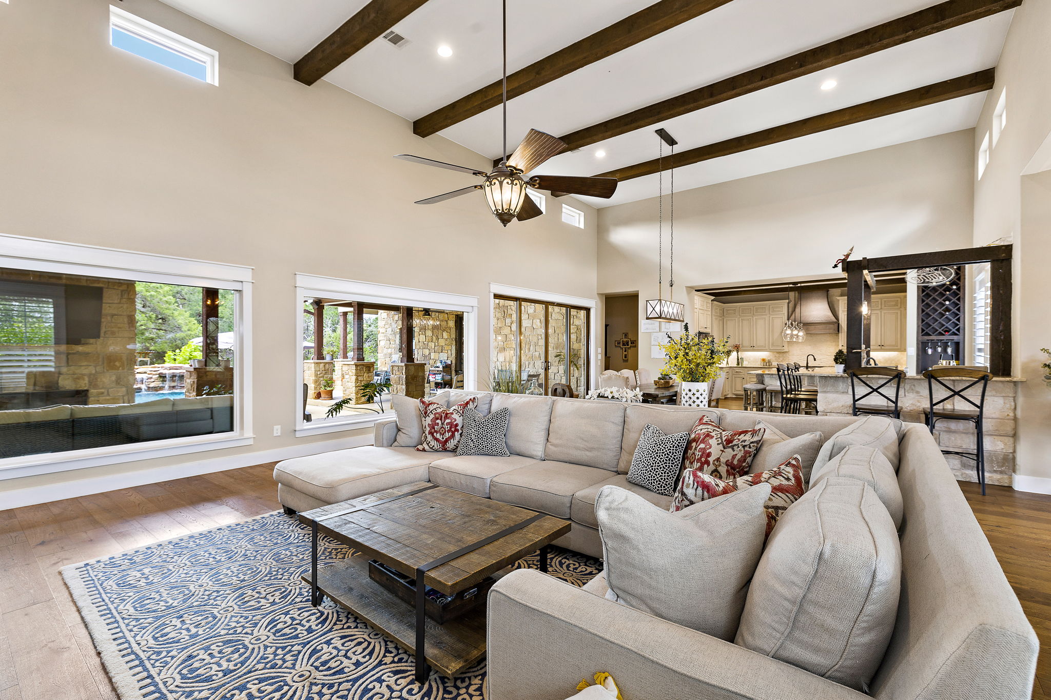 117 Covington Cove Georgetown, TX 78628 - Photo 8 of 40 Living room with hardwood / wood-style floors, ceiling fan, beam ceiling, recessed lighting, and a high ceiling