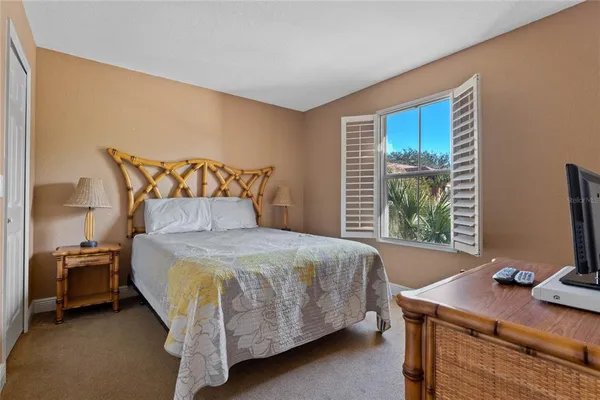 a bedroom with a bed and a desk