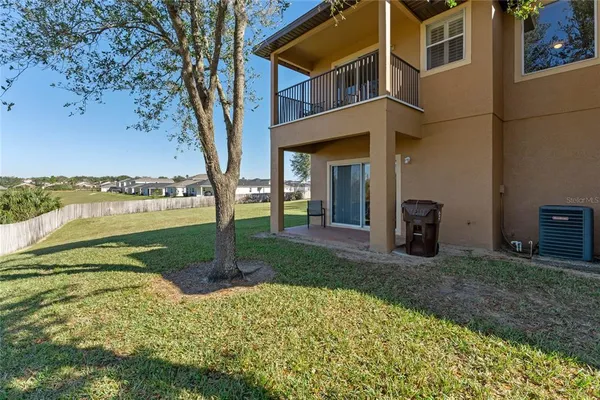 a view of a house with a yard and lake view