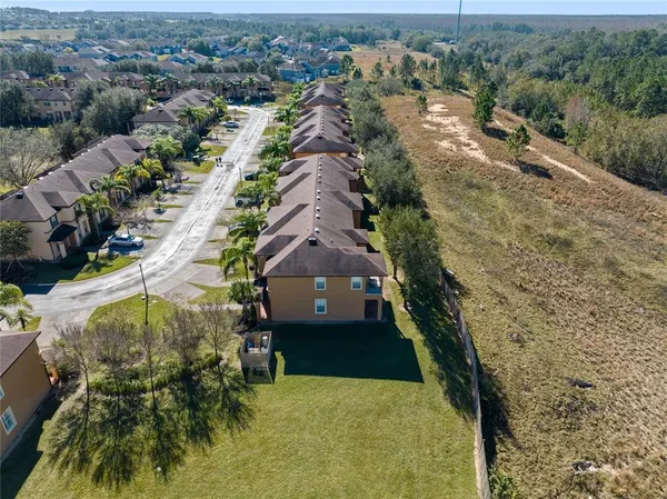 an aerial view of a house with a yard