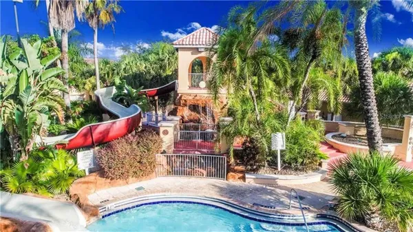 a view of a house with swimming pool and sitting area