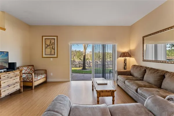 a living room with furniture and a lamp
