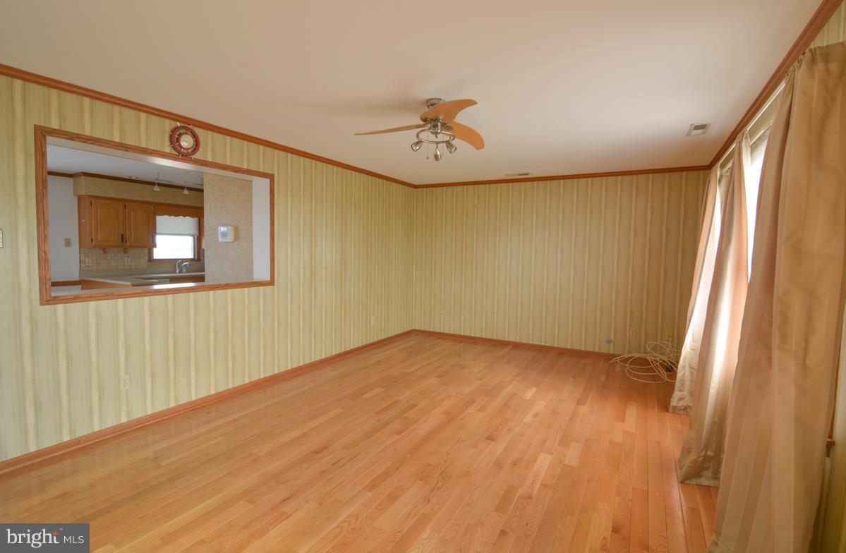 Living area that leads into eat-in kitchen area.