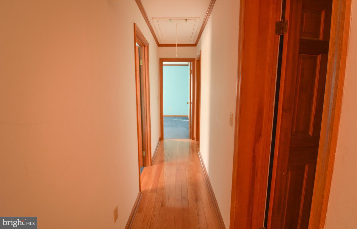 Hallway leading to 3 bedrooms.